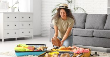 Woman packing suitcase for trip