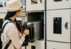 Woman storing luggage in locker
