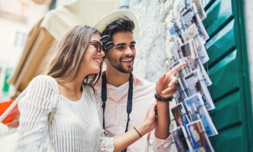 Couple buying postcards